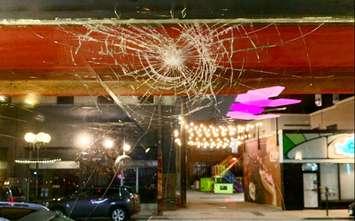 (Photo of smashed window at Phog Lounge, courtesy of Phog Lounge on Facebook)