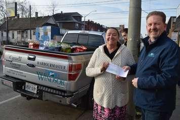 Street Help Homeless Centre administrator Christine Wilson-Furlonger of accepts a donation from Windsor Port Authority President and CEO Steve Salmons  on December 19, 2018. (Photo by Allanah Wills)