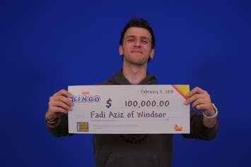 Fadi Aziz of Windsor claims his $100,000 cheque after winning at Instant Bingo Doubler. Photo courtesy OLG.