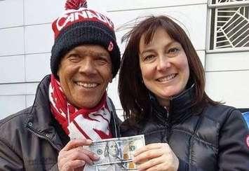 Anthoni Tambunan donating his strike pay with Jenny Laevens.  (Photo courtesy of Jenny Laevens)