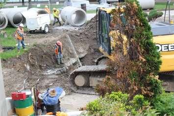 Construction workers dig where a sink hole opened up in Dieppe Park in Windsor, May 20, 2015.  (Photo by Adelle Loiselle)
