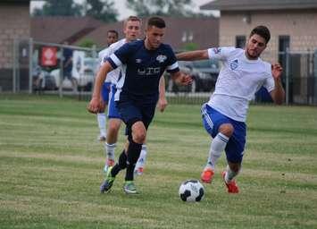 Mike Pio of the Windsor Stars dribbles past a defender in a game against ANB Futbol in League1 Ontario play at McHugh Park in Windsor, June 21, 2014. (Photo by Ricardo Veneza)