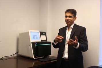 Dr. Raj Atikkuke explaining the equipment used for genome profiling at ITOS Oncology, July 5, 2017. (Photo by Maureen Revait) 