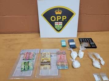 A seizure of drugs and cash is displayed at the OPP Essex County Detachment on January 24, 2023. Photo provided by Ontario Provincial Police.