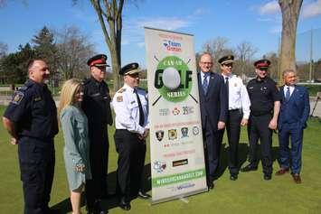 Windsor Fire Chief Steve Laforet, fourth from left, and Mayor Drew Dilkens, fourth from right, join sponsors and law-enforcement representatives at Roseland Golf and Curling Club, April 23, 2019. Photo by Mark Brown/Blackburn News.