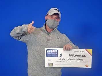 Chris Inch of Amherstburg shows off his $100,000 cheque at the OLG Prize Centre in Toronto, September 28, 2020. Photo provided by OLG.