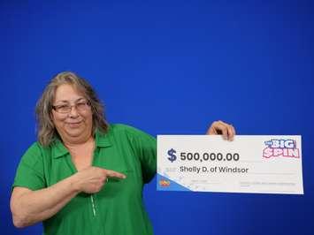 Shelly Desbien of Windsor holding her cheque for $500,000. Photo via OLG Communications 