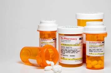 Prescription pills in plastic medicine bottles. (© Can Stock Photo / piedmont_photo)