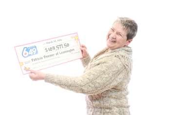 Lotto 6/49 winner Patricia Beemer stands with her cheque. (Photo courtesy the OLG)