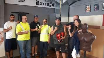 Andre Gorges, far left, of Border City Boxing and Alana Mariani, far right, from Fahrhall, pose with representatives in front of the new HVAC system at Border City Boxing in Windsor, September 14, 2018. Photo by Mark Brown/Blackburn News.