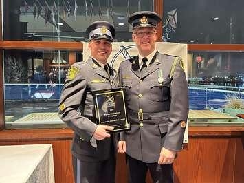 OPP Constable James (JJ) Lyman, left, accepts his award from OPP Provincial Marine Coordinator, Sergeant Dave Moffatt, January 22, 2023. Photo courtesy Ontario Provincial Police.