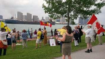 Protesters gather at the Windsor Riverfront for a rally against petroleum coke piles on the U.S. side of the Detroit River, June 26, 2013. File photo.
