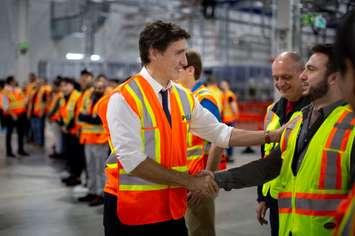 Prime Minister Justin Trudeau shakes hands with workers building the new electric vehicle battery plant in Windsor, March 14, 2024. Photo provided by Stellantis Canada.