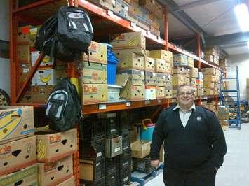 Salvation Army Captain Corey Vincent stands inside the Leamington warehouse.
