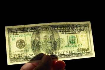 File photo of counterfeit $100US bill courtesy of © Can Stock Photo / Allex