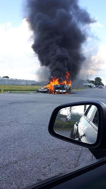 A vehicle fire from a two-car crash burns at Albuna Townline Rd and County Rd 18 in Leamington on June 24, 2017 (Photo courtesy of Turtle Guard/Facebook. Used with permission.)