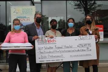 A cheque for $236,109 is presented by W.E. Care for Kids to Windsor Regional Hospital on July 13, 2021. Photo courtesy Windsor Regional Hospital Foundation.