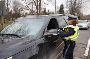 OPP officer checking for impaired drivers during the 2019 Festive RIDE Program. December 2019. (Photo by OPP West)