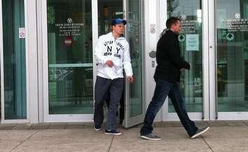 Windsor Spitfires' forward Ben Johnson (left) leaves the courthouse in downtown Windsor after a bail hearing this morning, March 19, 2013.