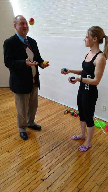 Larry Horwitz of the Downtown Windsor BIA tries juggling with Tia Nicoletti of the Windsor Circus School at the Chelsea Building in Windsor, April 13, 2017 (Photo by Mark Brown/Blackburn News)
