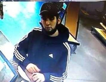 A surveillance camera screengrab of a suspect beleived to be passing fake U.S. currency at the Windsor Crossing outlet mall. Photo released February 18, 2019. Courtesy LaSalle Police Service/Twitter.