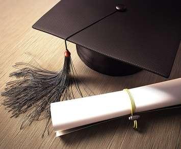 A graduation cap and diploma. File photo courtesy of  © Can Stock Photo / iDesign.