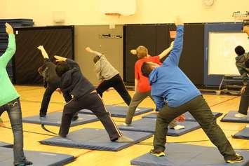 Grade 7 students at Tecumseh Vista Academy practice yoga during gym class. (BlackburnNews.com file photo)