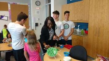 Ontario Education Minister Mitzie Hunter admires a craft made during a Focus on Youth summer program at David Suzuki School in Windsor on August 10, 2017. Photo by Mark Brown/Blackburn News.
