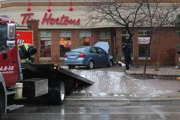 A car, which the Windsor Police Service says was stolen, ends up slamming into a Tim Hortons on Park St. W. at Goyeau St., February 7, 2017. (Photo by Mike Vlasveld)