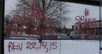 Vandalism on a bus shelter on Ouellette Ave. near Giles Blvd., shelters along Ouellette Ave between Wyandotte St. and Tecumseh Rd. hit with similar messages, December 13, 2017. (Photo by Maureen Revait) 