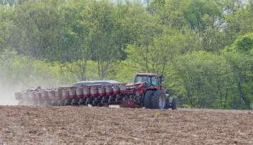 Farm tractor planting seeds in a field. (Photo courtesy of © Can Stock Photo / chas53)