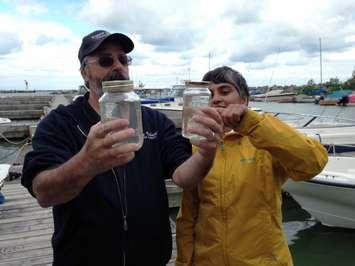 Then-Pelee Island Mayor Rick Masse and Raj Gill with Canadian Freshwater Alliance checking a water sample. Aug. 25, 2015 (Photo by Kevin Black)