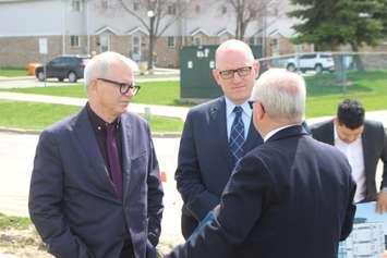 Jim Steele, CEO of the Windsor-Essex Community Housing Corporation, right, talks as Windsor Mayor Drew Dilkens, centre, and MP Adam Vaughan listen during a media event on Meadowbrook Lane in Windsor, April 23, 2019. Photo by Mark Brown/Blackburn News.