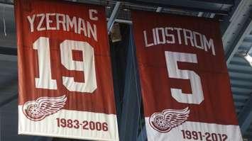 The retired numbers of Steve Yzerman and Nick Lidstrom  hanging in the rafters of Joe Louis Arena. (Photo by Aaron Zimmer)