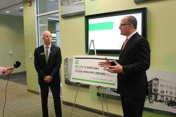 Windsor Mayor Drew Dilkens (right) receives a cheque for $15,000 from the TD Bank on Ouellette Ave. in Windsor, June 15, 2017. (Photo by Mike Vlasveld) 