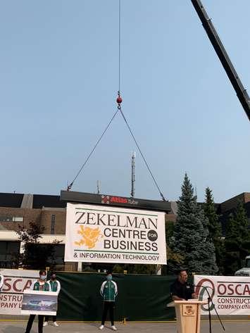A sign identifying the future St. Clair college Zekelman Centre of Business and Information Technology is lowered into place, September 16, 2020. Photo provided by St. Clair College.