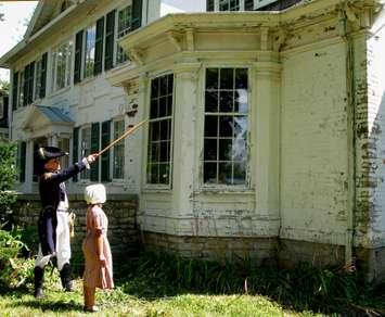 Artist Peter Rindlisbacher (left) and his daughter Victoria (right) tour the grounds of the Belle Vue House in Amherstburg in costume. (Photo courtesy Belle Vue Conservancy)