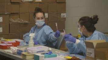 Pharmacy technicians drawing up doses of COVID vaccines. (File photo by Colin Gowdy, BlackburnNews)