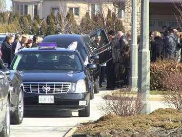 Family and friends of nine-year-old Gabrielle Greenwood load her casket into the back of a hearse, outside of the Families First Funeral Home and Chapel in Windsor. 
