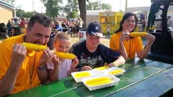Enjoying corn at the 2013 Tecumseh Cornfest. (Photo by Ricardo Veneza)