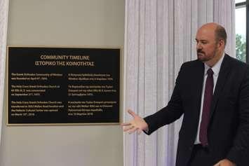 Panos Sechopoulos, president of the Greek Orthodox Community of Windsor, helps unveil a community timeline plaque at the Hellenic Cultural Centre in Windsor, May 11, 2018. Photo by Mark Brown/Blackburn News.