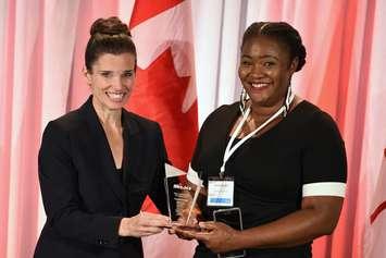Pamela Ovadje (right) receiving the Mitacs Award for Outstanding Innovation–Postdoctoral from Honourable Kirsty Duncan, Minister of Science, Government of Canada in Ottawa November 24, 2015. (Photo provided by Mitacs) 
