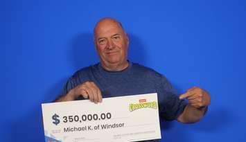 Michael Kennedy of Windsor shows off his $350,000 prize cheque at the OLG Prize Centre in Toronto, May 8, 2024. Photo provided by OLG.