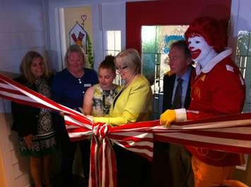 JC Leclair (middle left) and Ronald McDonald House Executive Director Margaret Anderson (middle right) cut the ribbon, opening Windsor's new Ronald McDonald House within Windsor Regional Hospital. They're joined by other charity and hospital officials, and Ronald McDonald, May 6, 2016. (Photo by Mike Vlasveld)