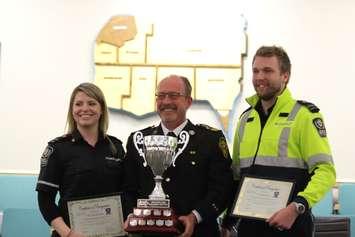 Paramedic Tricia Rousseau, left, Essex-Windsor EMS Chief Bruce Krauter and Chris Kirwan, right, present the 2015 National Paramedic Competition award at Essex County Council, May 6, 2015. (Photo by Jason Viau)