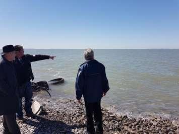 Chatham-Kent-Leamington MP Dave Van Kesteren, left, looks at the eroding western shoreline on Pelee Island with Deputy Mayor Dave Delillis, pointing, and Tim Byrne of ERCA. Photo provided by Adam Roffel.
