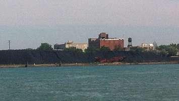 BlackburnNews.com file photo of the larger of two piles of petroleum coke on the banks of the Detroit River.