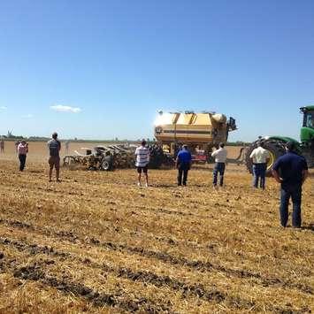 Farmers watch a demonstration of strip tillage equipment July 30, 2015 (Photo by Simon Crouch) 