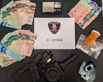 Windsor police display a seizure of cash and weapons following a raid on November 22, 2022. Photo provided by Windsor Police.