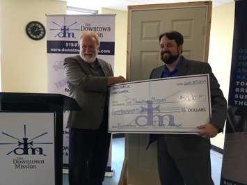 David Armour with the United Church of Canada Foundation presents a $50,000 cheque to Ron Dunn with the Downtown Mission, September 30, 2019. (Photo by Maureen Revait) 